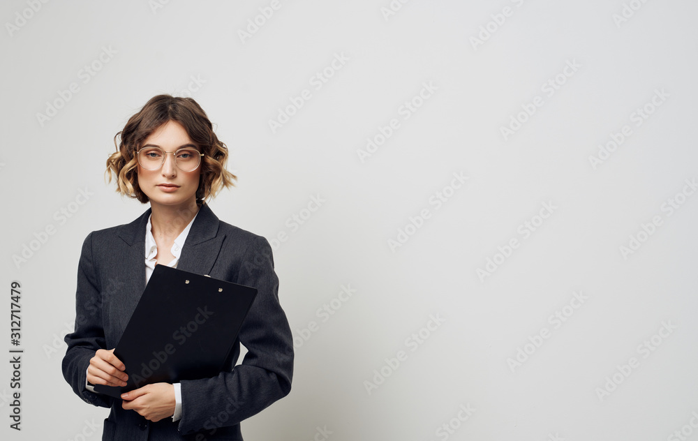 business woman standing in front of a wall business woman standing in front of a wall