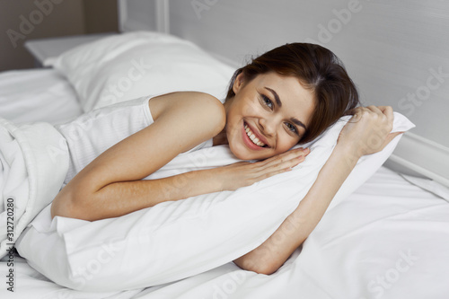 young woman lying on bed