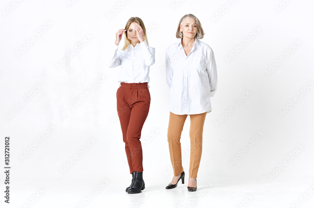 Grandmother and granddaughter are standing nearby Grandmother and granddaughter are standing nearby