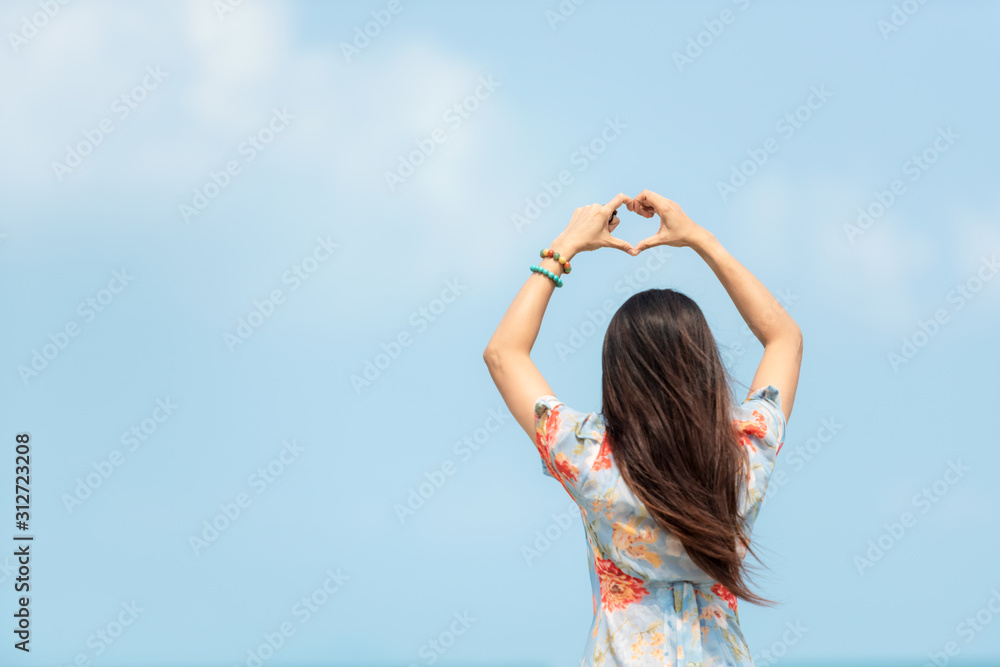 Summer Vacation. Traveler women relaxing and raise hand heart shape joy fun on the beach, so happy and luxury and destination in holiday summer. Tourism chill on sand. Summer Vacation. Traveler women relaxing and raise hand heart shape joy fun on the beach, so happy and luxury and destination in holiday summer. Tourism chill on sand.