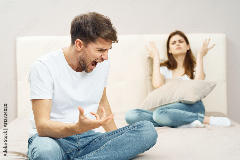 young couple sitting on sofa and watching tv young couple sitting on sofa and watching tv