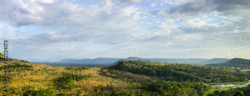Fototapeta Naklejka Na Ścianę i Meble -  Landscape view of forest, mountain, and cloudy sky at border of Thailand and Lao