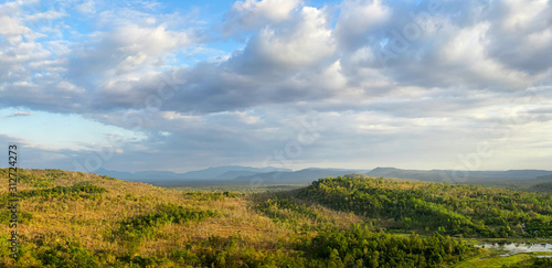 Landscape view of forest, mountain, and cloudy sky at border of Thailand and Lao © toonzzz