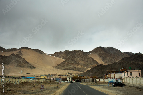 View landscape beside road with Indian people drive car on Srinagar Leh Ladakh highway go to view point of Confluence of the Indus and Zanskar River at Leh Ladakh in Jammu and Kashmir, India in winter