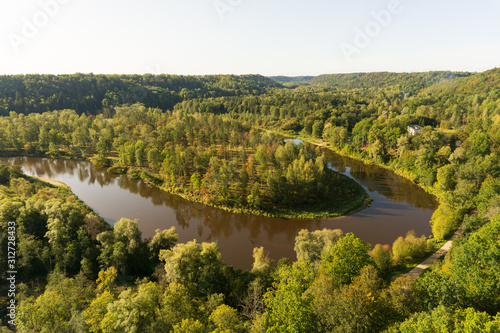Colorful autumn morning sunrise at forest covered picturesque Gauja river valley near Sigulda