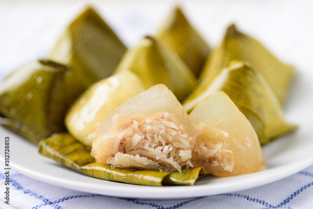 Thai dessert (Khanom Tian), sweet stuffed dough pyramid wrapped by banana leaf Thai dessert (Khanom Tian), sweet stuffed dough pyramid wrapped by banana leaf