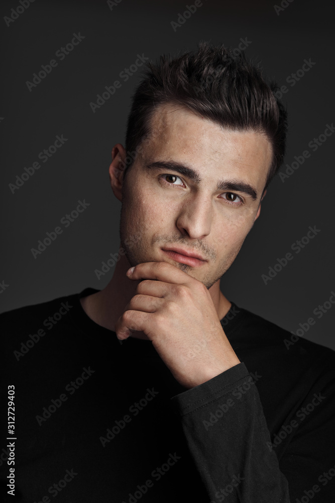 young man with finger on his lips young man with finger on his lips