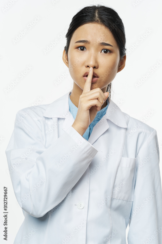 portrait of a woman with finger on her lips portrait of a woman with finger on her lips