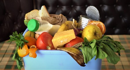 Household food waste. Uneaten spoiled foods in bin: bread, bakery, vegetables, fruits milk. Families throw away meals