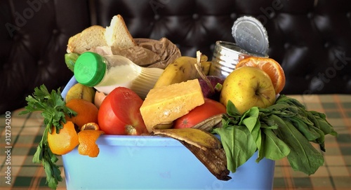 Household food waste. Uneaten spoiled foods in bin: bread, bakery, vegetables, fruits milk. Families throw away meals