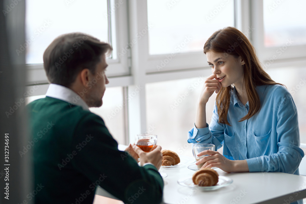 young couple having breakfast in the kitchen young couple having breakfast in the kitchen