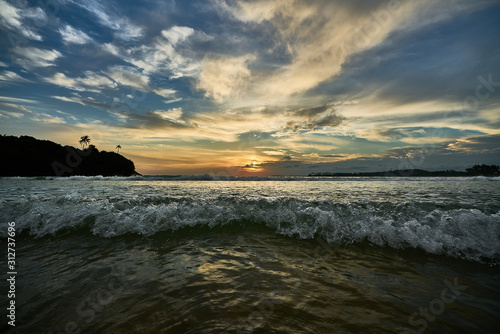 waves crashing during a sunset