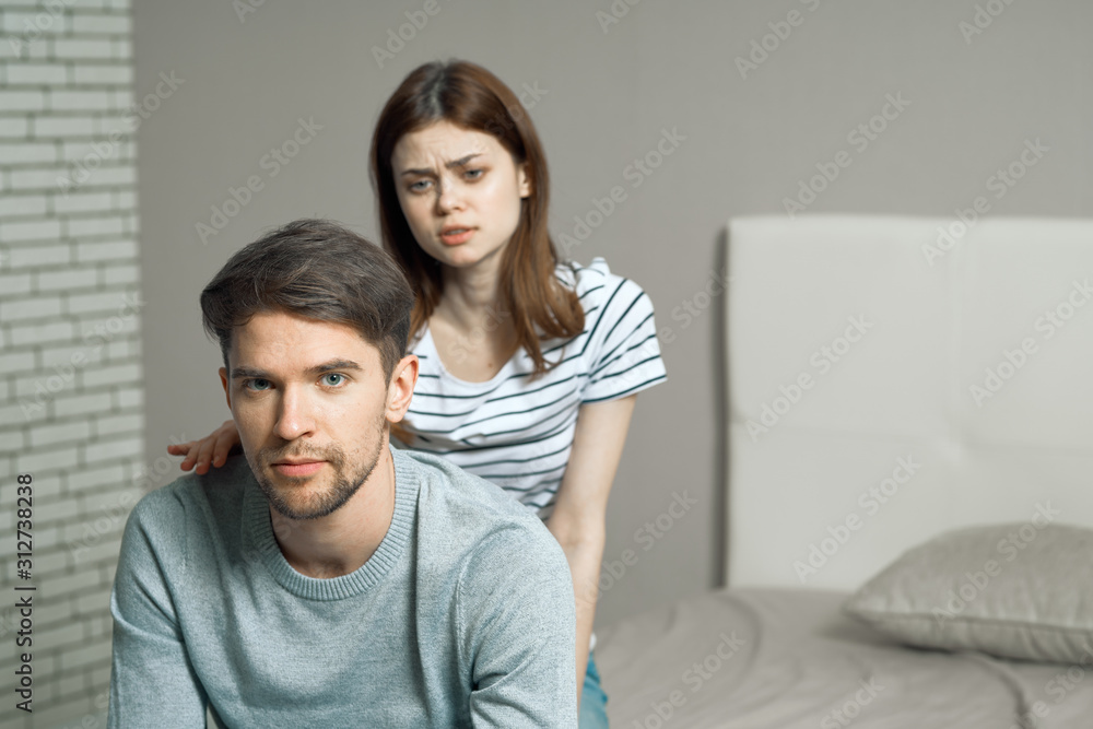 happy couple sitting on sofa and looking at camera happy couple sitting on sofa and looking at camera
