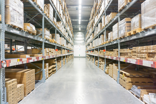 These boxes are tidy on shelves in a factory warehouse.