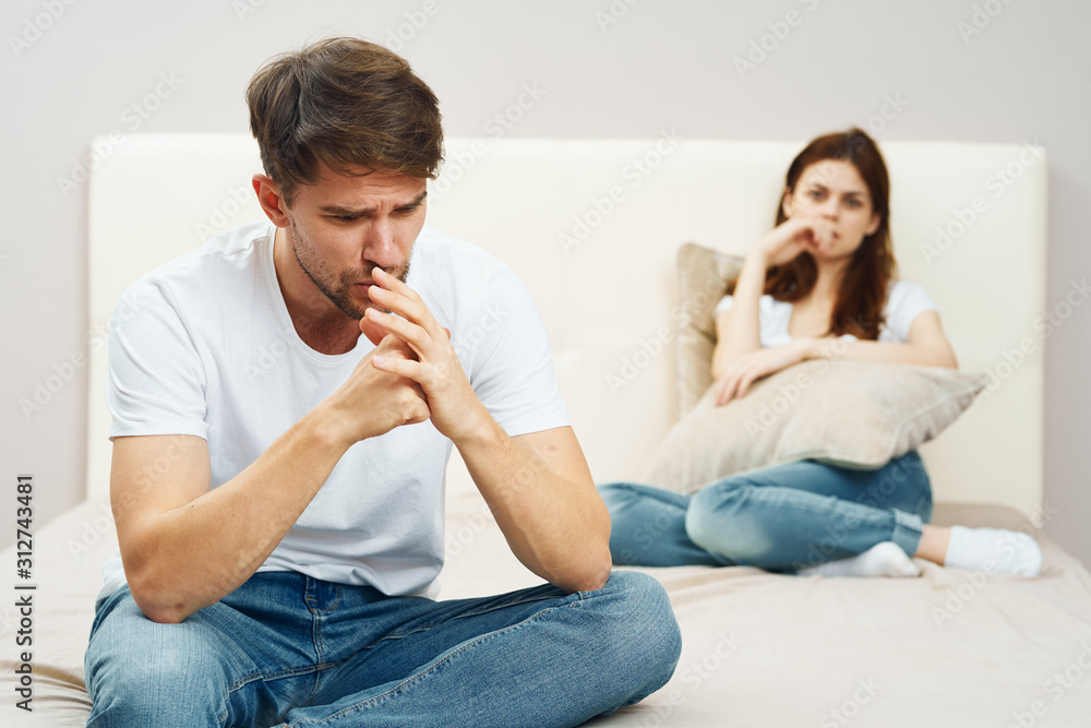 couple sitting on sofa and watching tv couple sitting on sofa and watching tv