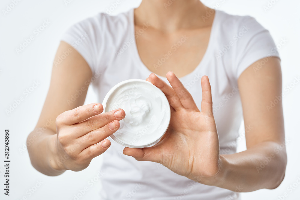 woman applying moisturizer cream on her face woman applying moisturizer cream on her face