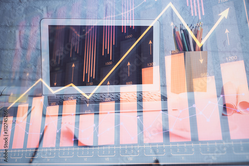 Stock market chart hologram drawn on personal computer background. Double exposure. Concept of investment. © peshkova
