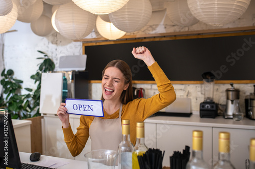 Young woman feeling happy for opening her coffee place photo