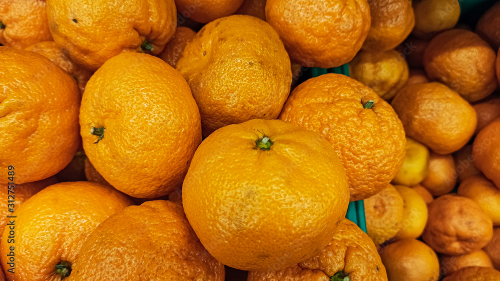 Healthy and organic oranges at the market. Lots of fresh orange fruits background. Healthy and organic oranges at the market. Lots of fresh orange fruits background.