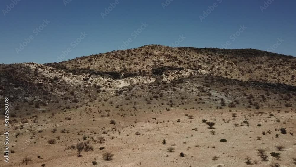 4K aerial drone video of gravel plains and Erongo Mountains near town Usakos, B1 highway to west coast of Namibia and dry waterless hot bushy savanna in Karibib District, central Namibia 4K aerial drone video of gravel plains and Erongo Mountains near town Usakos, B1 highway to west coast of Namibia and dry waterless hot bushy savanna in Karibib District, central Namibia