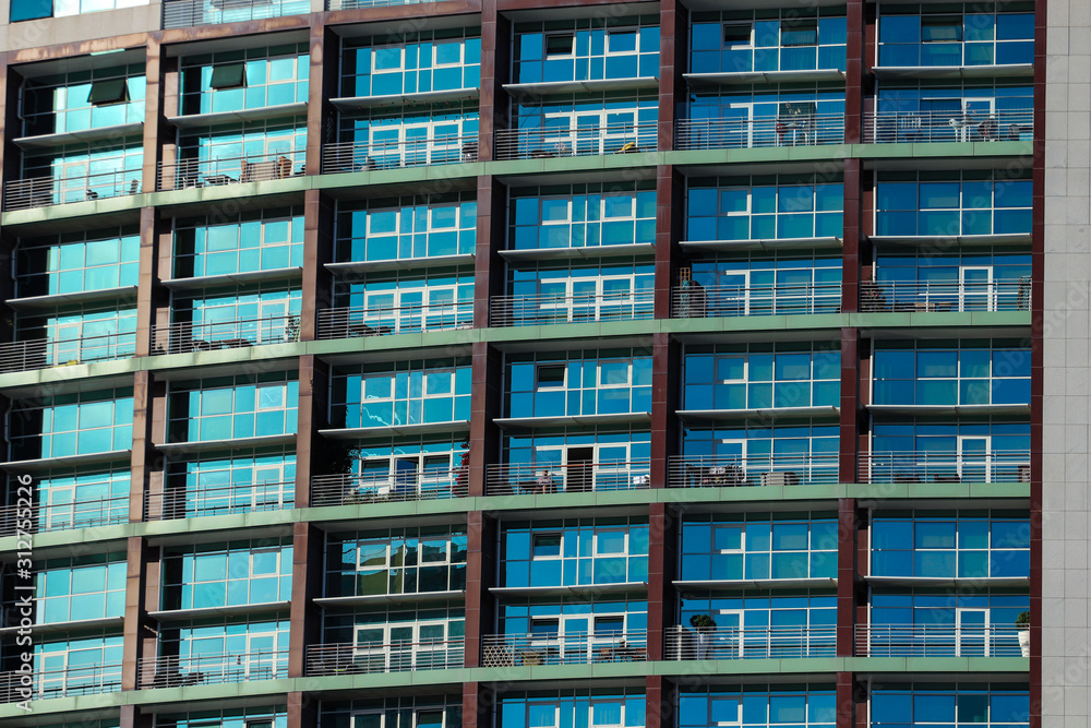 Multiple windows on a large apartment building Multiple windows on a large apartment building