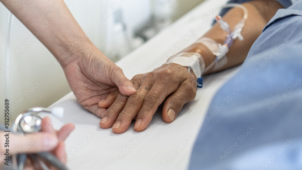 Obraz premium Elderly senior aged patient on bed with geriatric doctor holding hands for trust and nursing health care, medical treatment, caregiver and in-patient ward healthcare in hospital