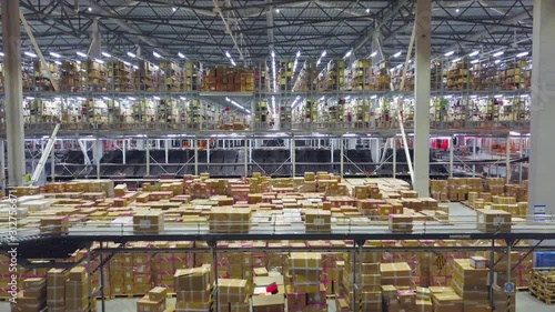 Large modern warehouse with cardboard boxes inside on logistic center, AERIAL