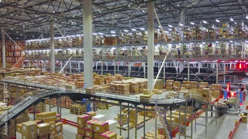 Industrial interior big modern logistic terminal,conveyor with boxes,aerial shot