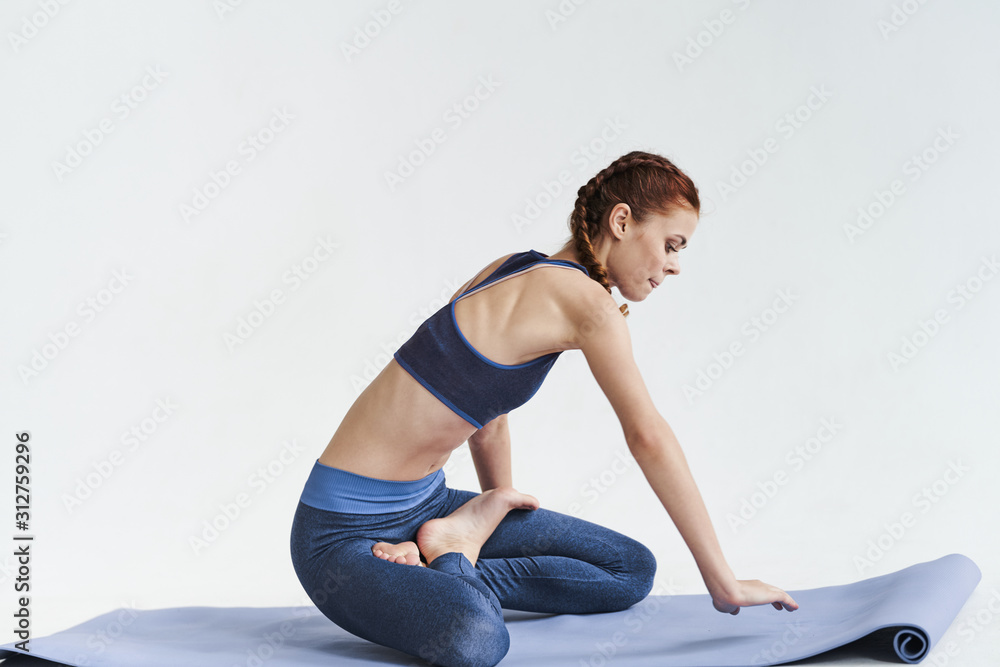 Fototapeta premium young woman doing stretching fitness exercise at yoga