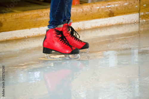 City ice rink. People ride on an ice rink. Skates.