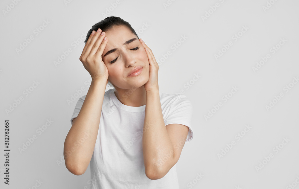 young woman with headache isolated on white young woman with headache isolated on white