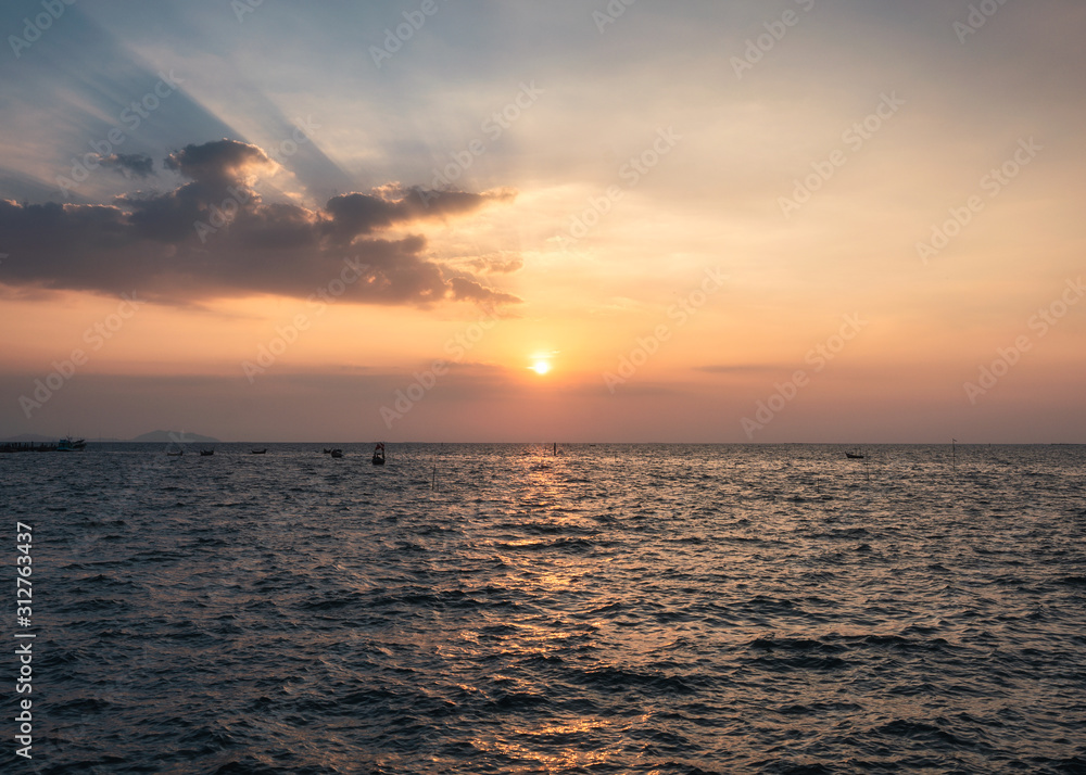 Tropical sea with fishing boats at evening
