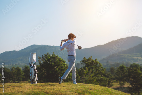 Side view, Asian Man hiting golf ball on the golf course in summer. sport, golfer concept.