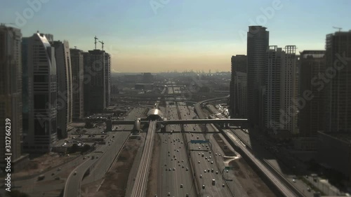 Aerial view of a big urban highway, modern skyscrapers and distant seaport. Dubai, UAE photo