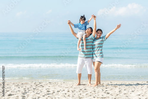 Asian happy family have fun fly on the beach for leisure and destination. Family people tourism travel enjoy in summer and holiday. Travel and Family Concept.