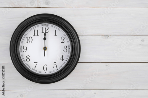 wall round clock black white with number and clockwise on twelve o'clock or 12 pm am and noon or midnight for time out or break working and school or lunch on wood wall or top view table with space