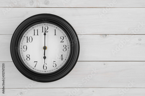 Wallpaper Mural wall round clock black and white with number and clockwise on six o'clock straight or 6 am pm for working time start or go to school and morning wake up on white wood wall or top view table with space Torontodigital.ca