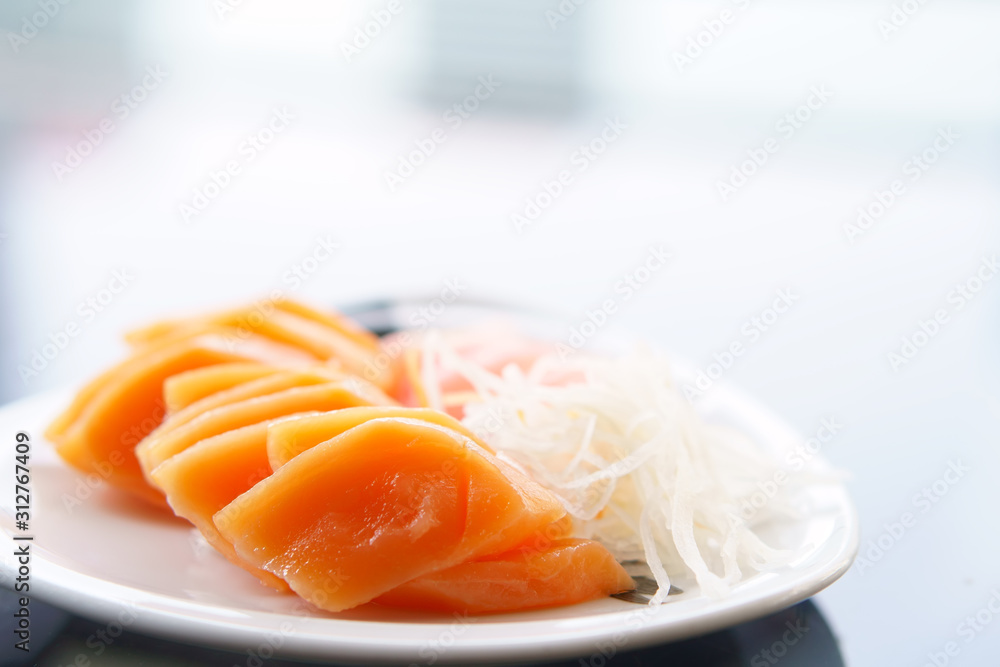 delicious raw salmon and fresh fish with vegetable or sliced radish in dish on table for healthy food and diet with omega 3 oil at lunch or dinner in japanese food restaurant on white space background delicious raw salmon and fresh fish with vegetable or sliced radish in dish on table for healthy food and diet with omega 3 oil at lunch or dinner in japanese food restaurant on white space background
