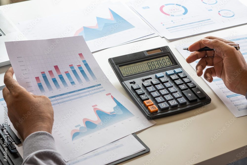 businessman working calculate data document graph chart report marketing research development planning management strategy analysis financial accounting. Business office concept. businessman working calculate data document graph chart report marketing research development planning management strategy analysis financial accounting. Business office concept.