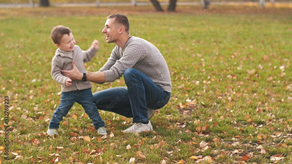 Boy runs from mother, and father catches him Boy runs from mother, and father catches him