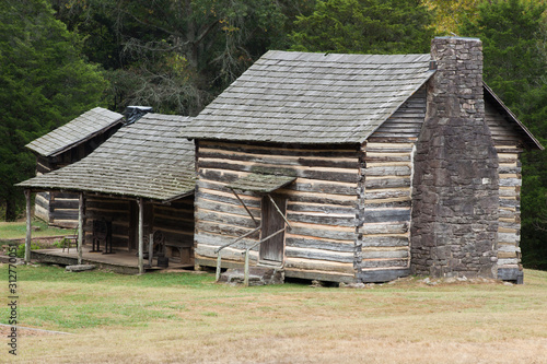 Log Cabin in a field of grass