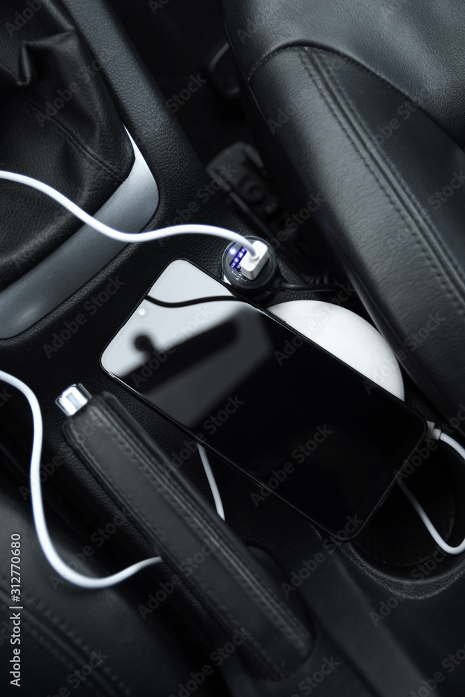 Mobile phone, smartphone charge battery, wireless charging in the car plug close up