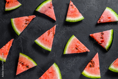 Red watermelon on dark background. Summer concept. Flat lay, top view