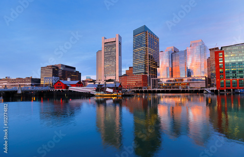 Boston Harbor at sunrise viewing from Fan Pier Park. Boston Harbor is a natural harbor and estuary of Massachusetts Bay 