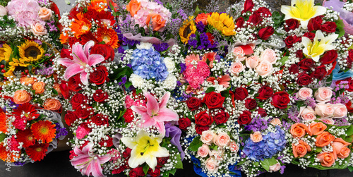 Many fresh flowers with droplets in bouquet at flower market,pattern topview background,selective focus © sirinyapak