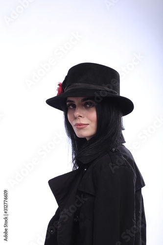 portrait of a young brunette in a black hat