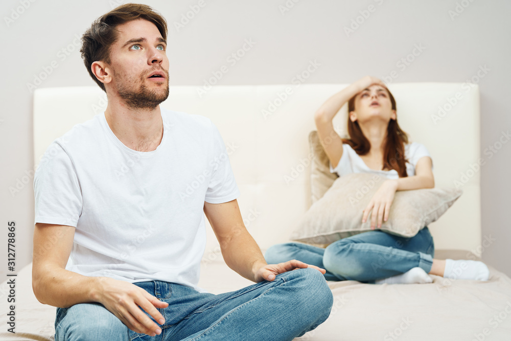 young couple sitting on sofa and watching tv young couple sitting on sofa and watching tv