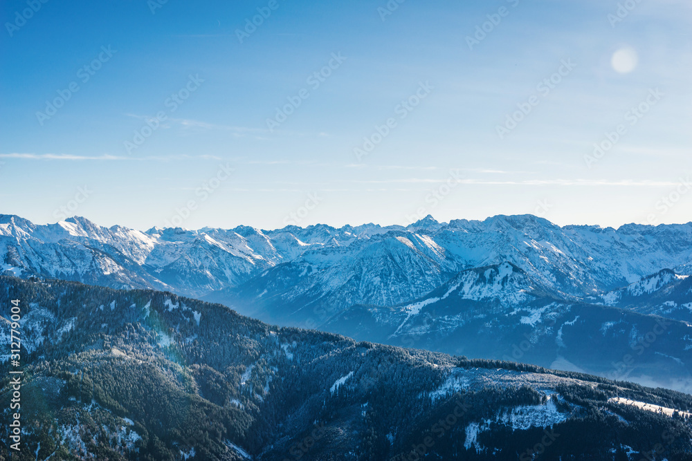Aerial view of winter mountain landscape with snow covered peaks. Bavarian mountains in the Allgaeu area near Oberstdorf, Germany