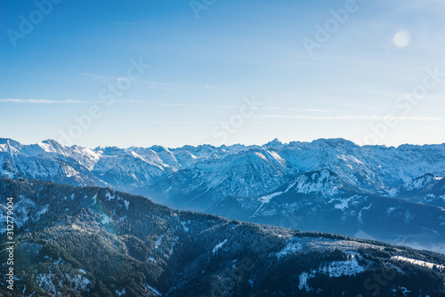 Aerial view of winter mountain landscape with snow covered peaks. Bavarian mountains in the Allgaeu area near Oberstdorf, Germany