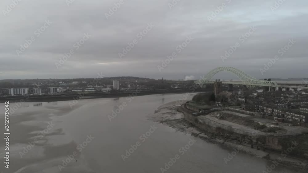 Aerial view River Mersey Silver Jubilee bridge Widnes & Runcorn waterfront. Slow pull back reveal. Aerial view River Mersey Silver Jubilee bridge Widnes & Runcorn waterfront. Slow pull back reveal.